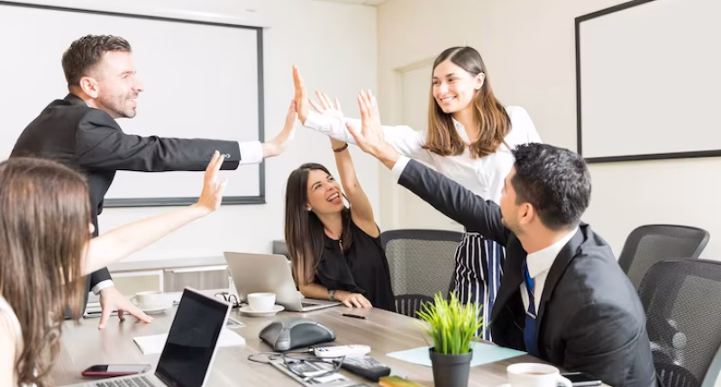 happy-subordinates-giving-high-five-after-successfully-undertaking-new-project-boardroom_662251-193
